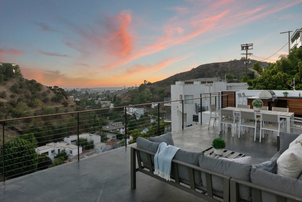 Modern terrace with city view at sunset.