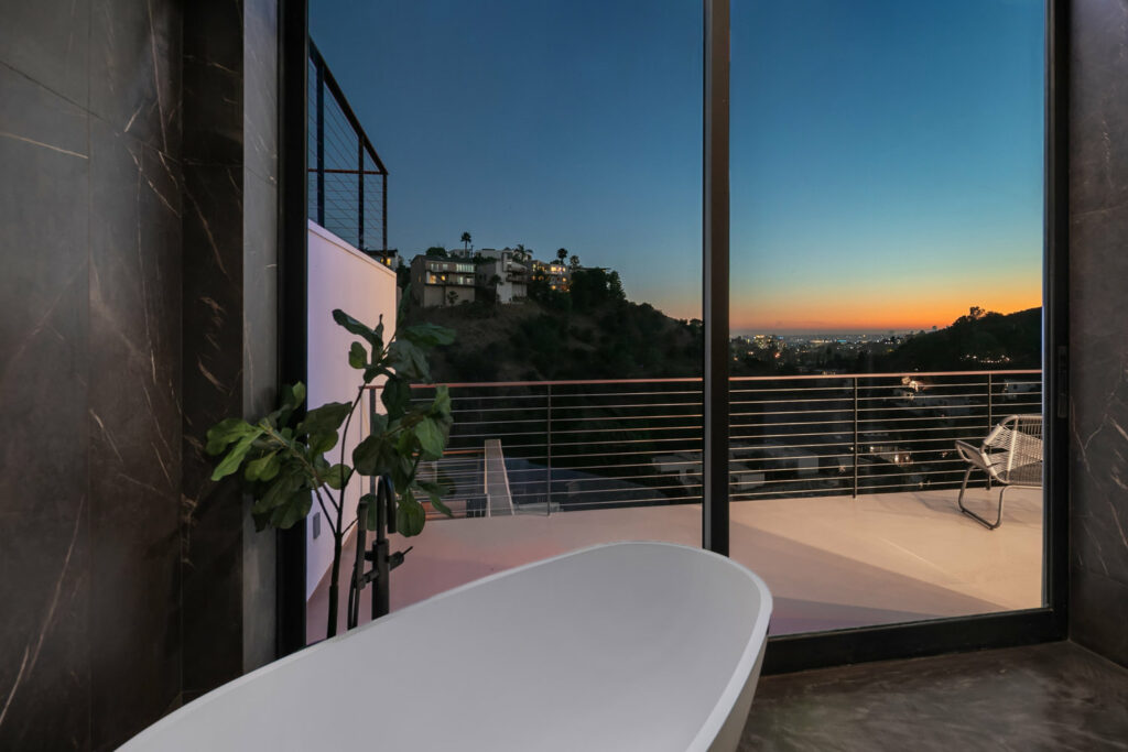 Luxury bathroom with city view at sunset