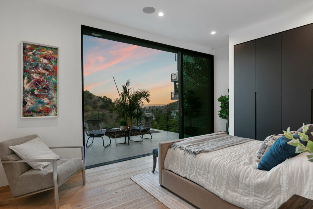 Modern bedroom with sunset view and outdoor patio access