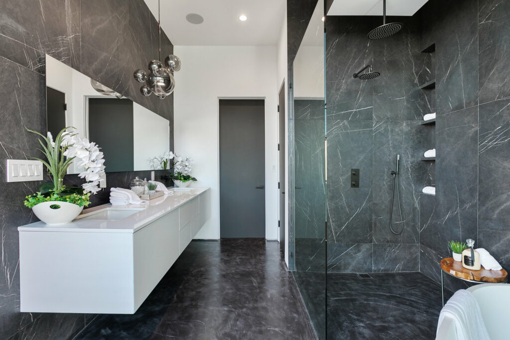Modern bathroom with marble tiles and double shower.