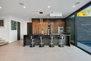 Modern kitchen interior with pool view.