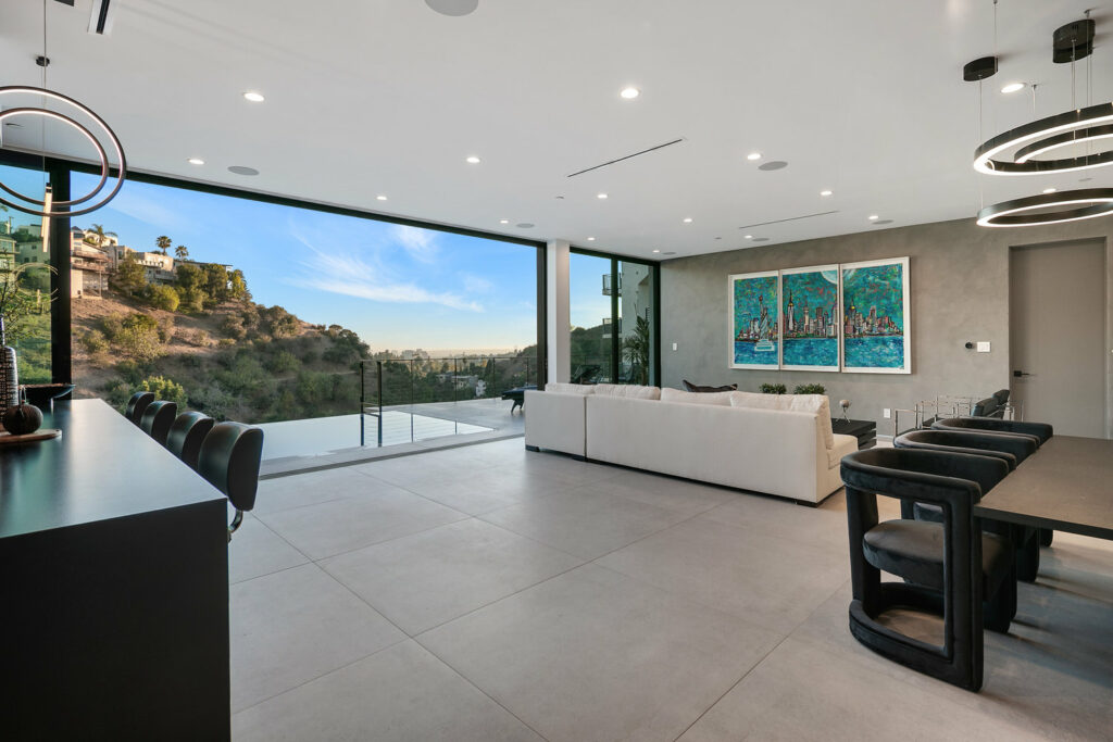 Modern dining room with panoramic hillside view.