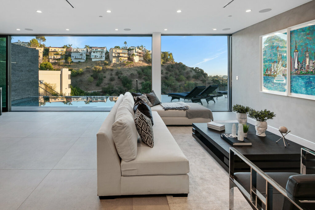Modern living room with infinity pool view and artwork.