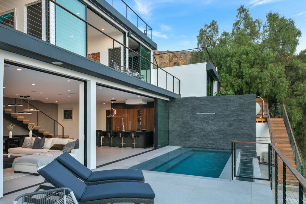 Modern house exterior with pool and open living space.