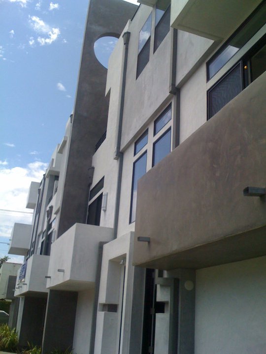 Modern architecture, geometric building facade, blue sky.