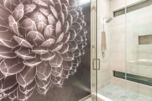 Modern bathroom with floral tile art shower wall.