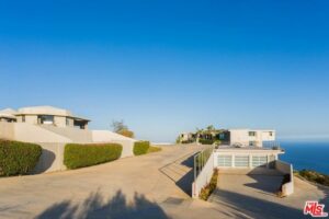 Luxury coastal homes with ocean view at sunset.