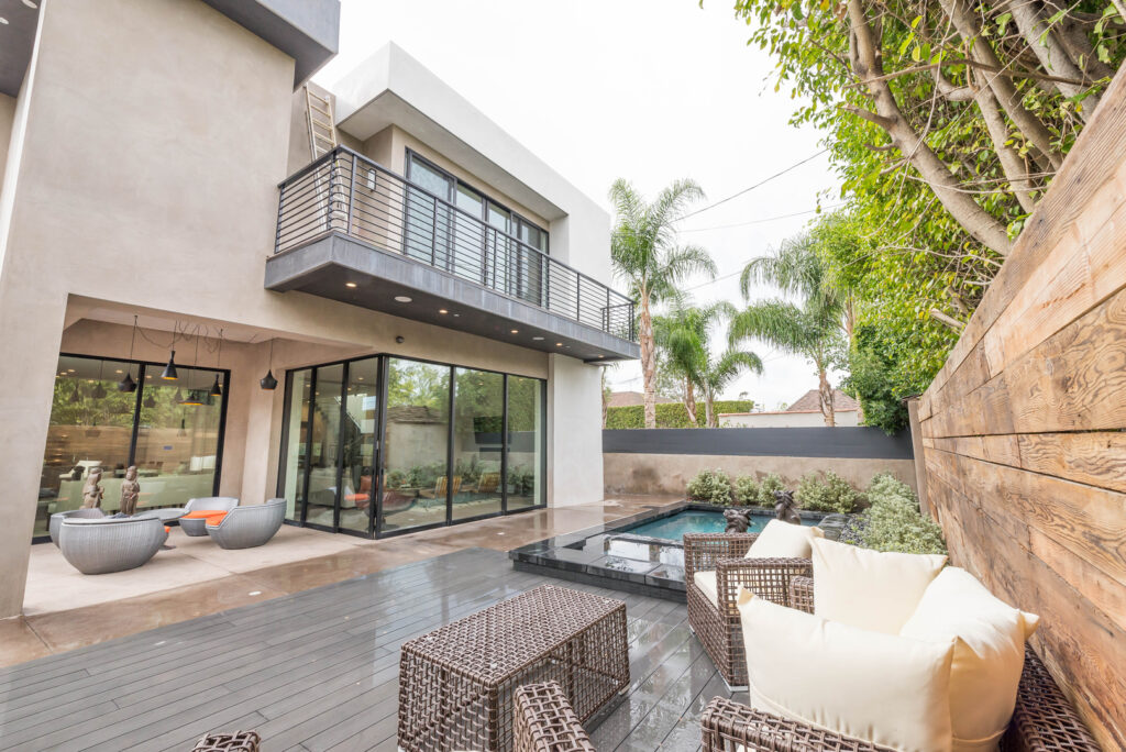 Modern backyard with pool and patio seating area.