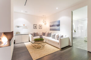 Modern living room with fireplace and chic decor.