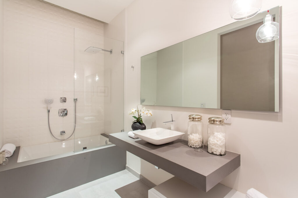 Modern bathroom with glass shower and vessel sink.