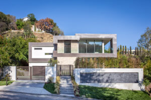 Modern luxury house with large windows and natural surroundings.