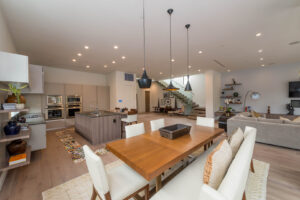 Modern open-concept living space with kitchen and stairs.
