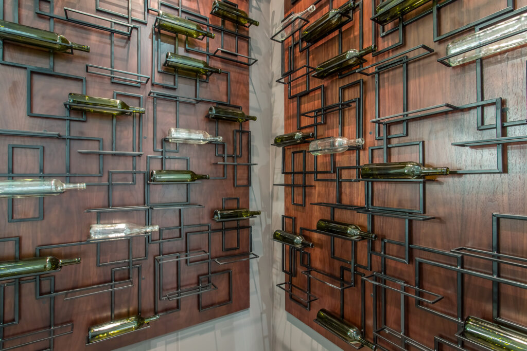 Wine bottles on a contemporary wooden wall rack.