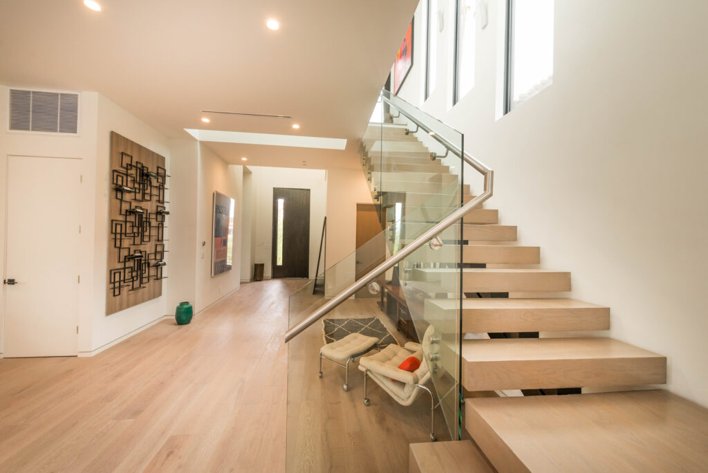 Modern home interior with wooden staircase and minimalist decor.