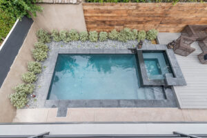 Aerial view of backyard with swimming pool and patio.