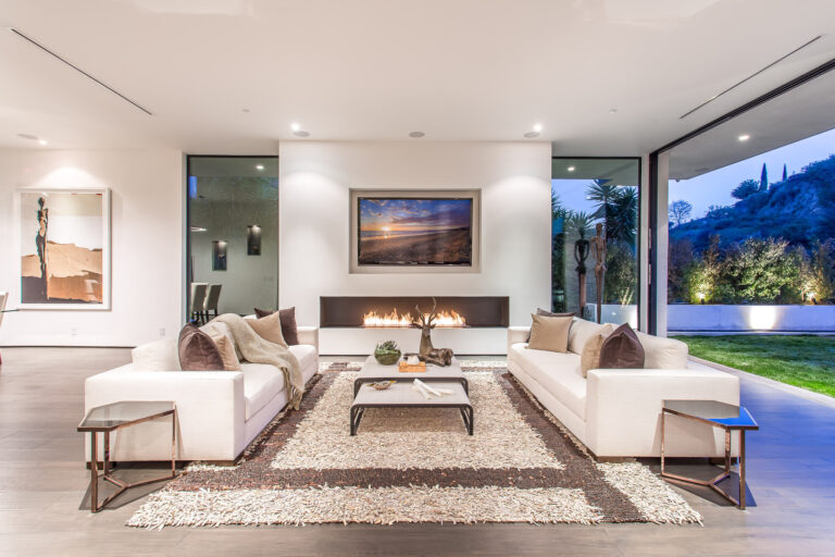 Modern living room with fireplace and outdoor view.