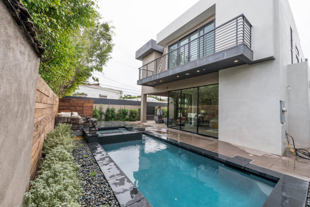 Modern home exterior with pool and patio area.