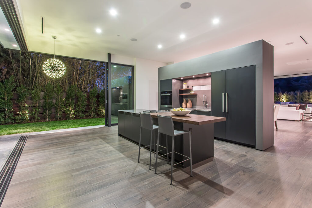 Modern kitchen interior with outdoor view at night.