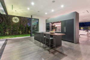 Modern kitchen interior with outdoor view at night.