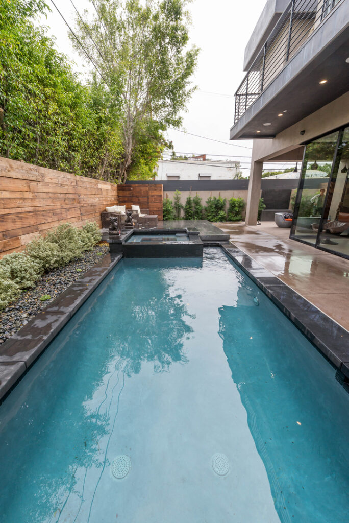 Modern backyard with pool and patio area.