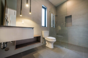 Modern bathroom with shower and toilet.