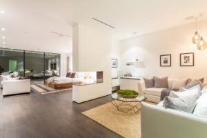Modern open-plan living room with integrated bedroom and fireplace.