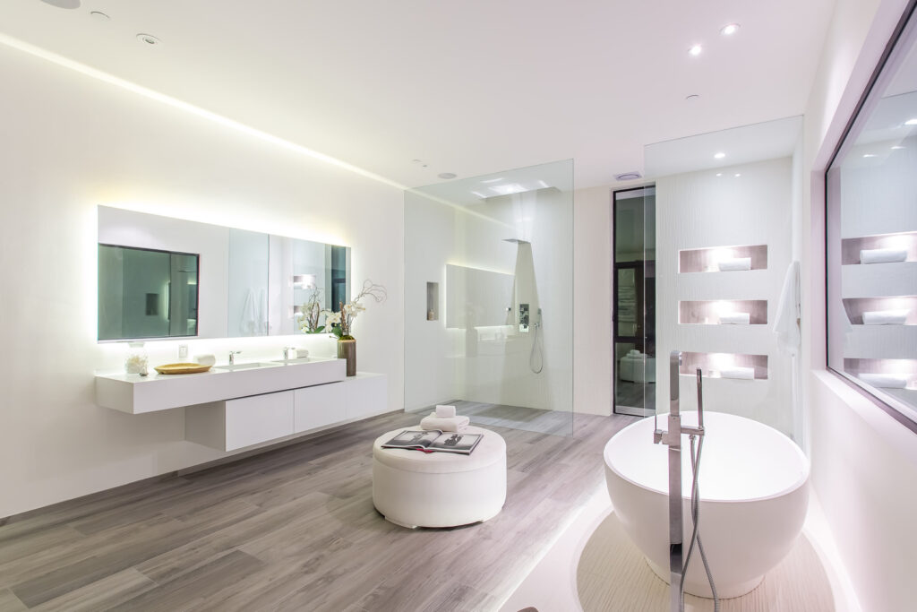 Modern bathroom with LED lighting and freestanding tub.