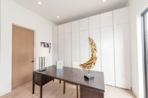 Modern room with artistic golden sculpture on desk.