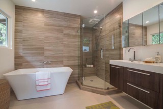 Modern bathroom with freestanding tub and glass shower.