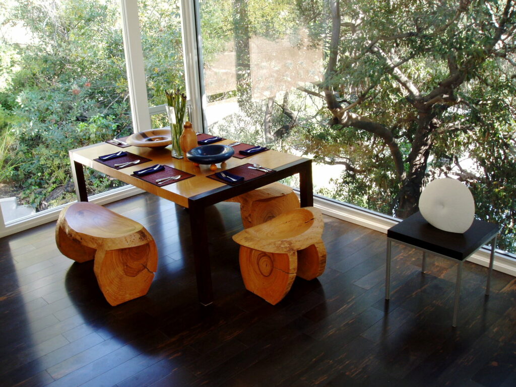 Modern dining room with wooden table and natural light.