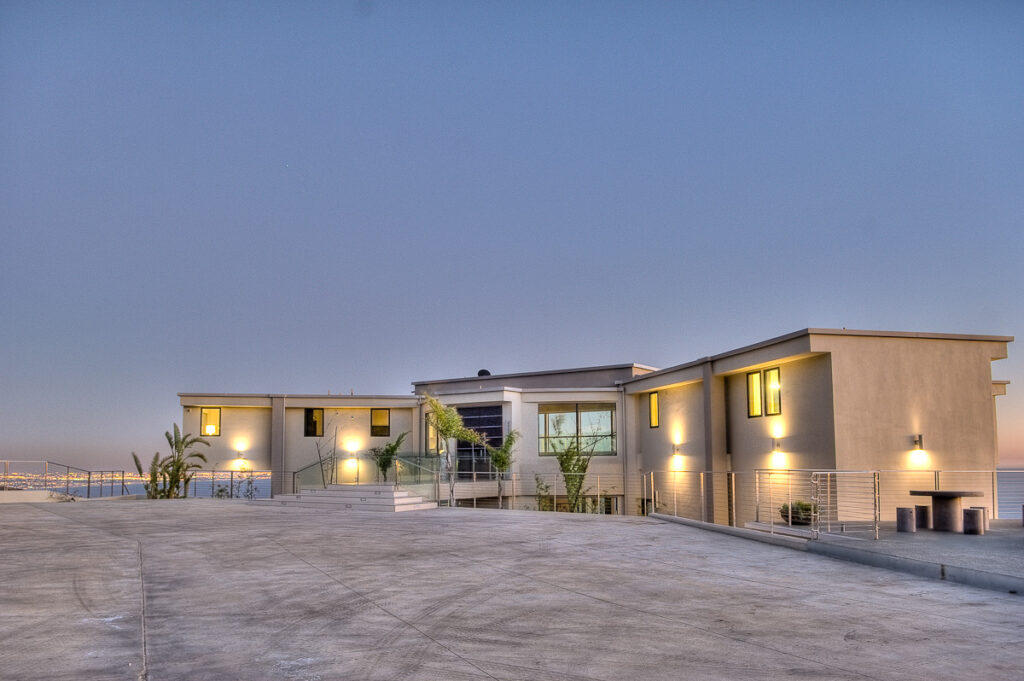 Modern house exterior at twilight with lights on