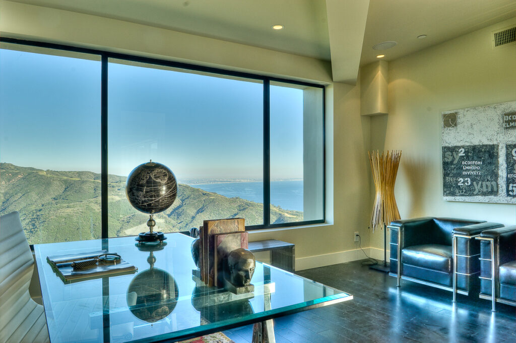 Modern room with ocean view and glass table.