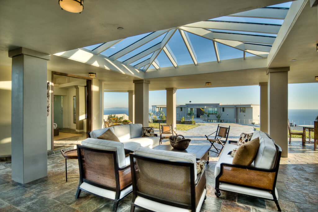 Luxurious patio with ocean view and modern furniture.