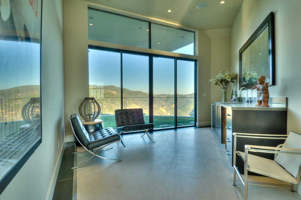 Modern living room with mountain view and large windows.