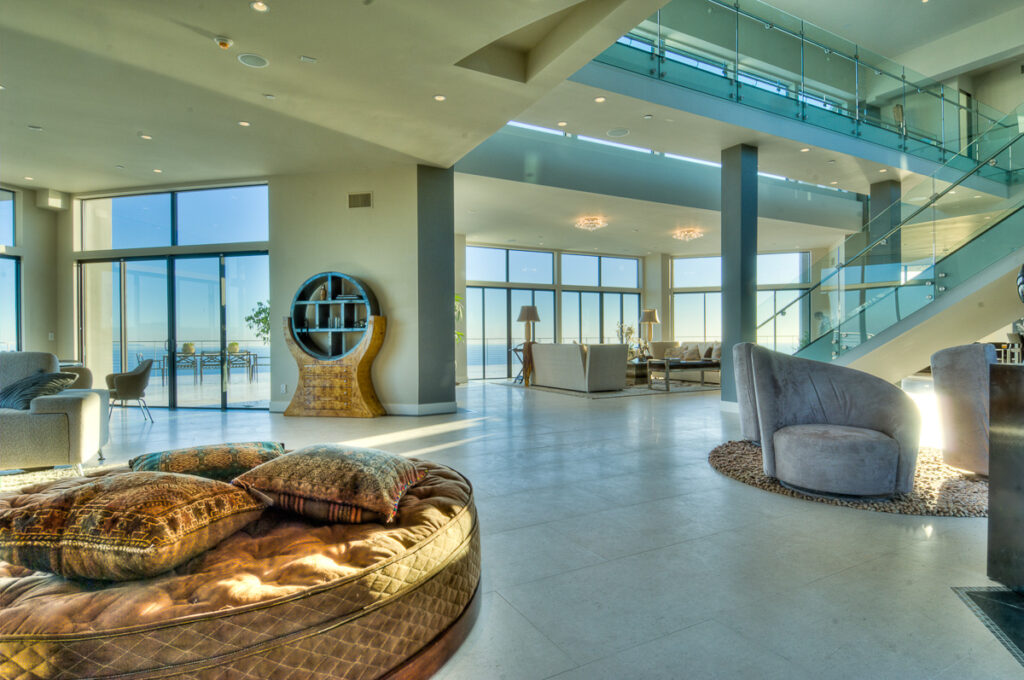 Luxurious modern home interior, ocean view, natural light.
