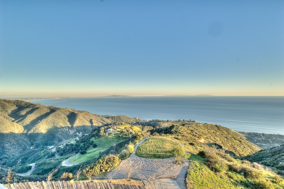Coastal hills with ocean view at sunset.