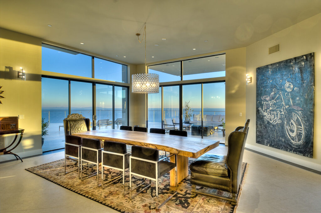 Modern dining room with ocean view and unique art.