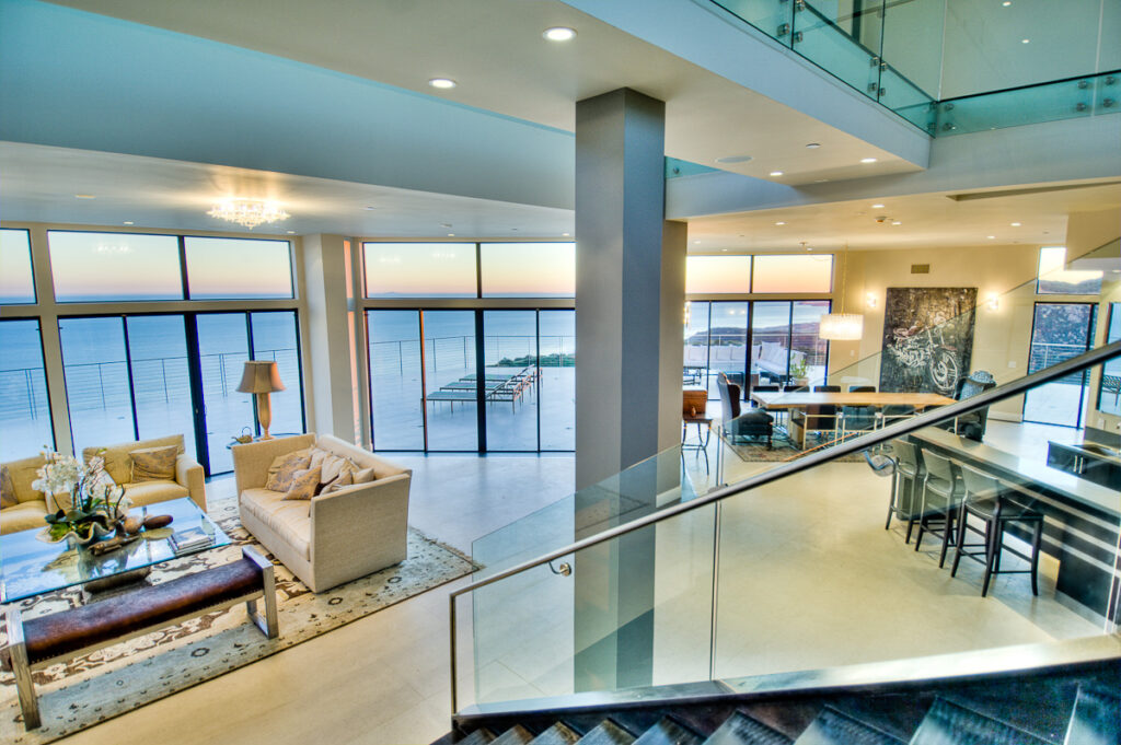 Modern waterfront home interior with sunset view.