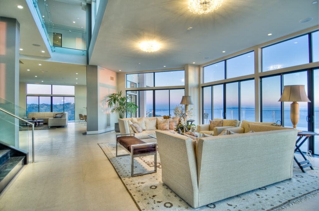 Luxurious living room with ocean view at dusk