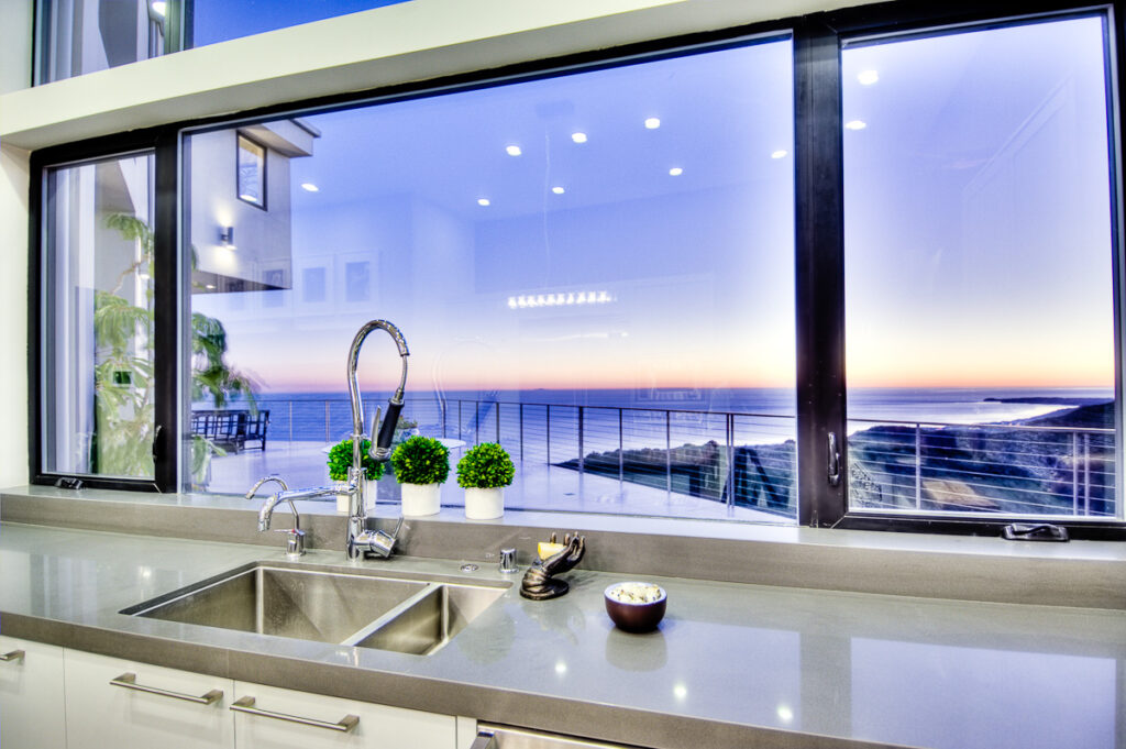 Modern kitchen interior with ocean sunset view