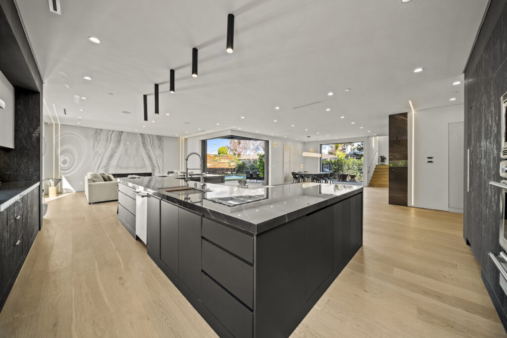 Modern kitchen interior with marble accents and open layout.