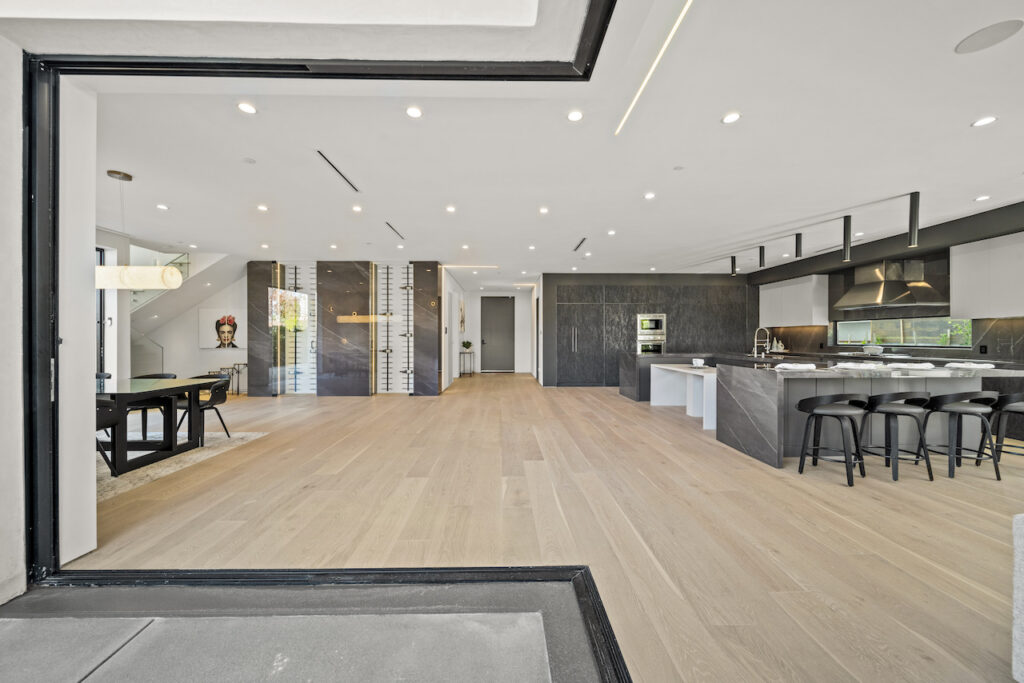 Modern kitchen interior with island and open floor plan.