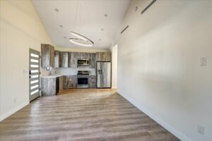 Modern kitchen interior with wood accents and unique lighting.