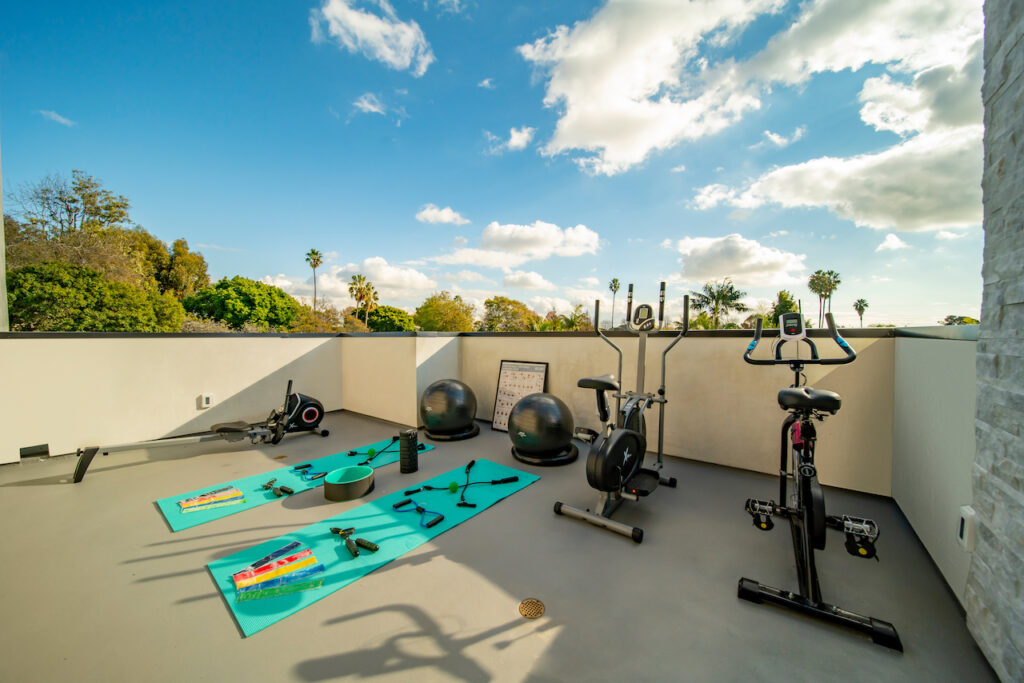 Outdoor home gym with exercise equipment and scenic view.
