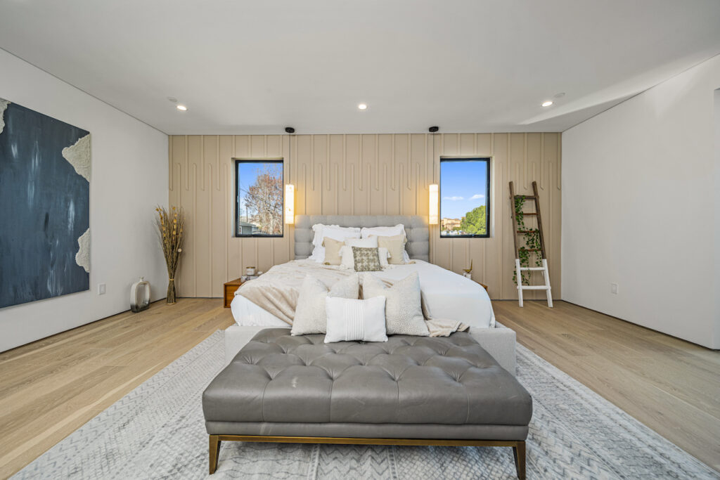 Modern bedroom with natural light and elegant decor.