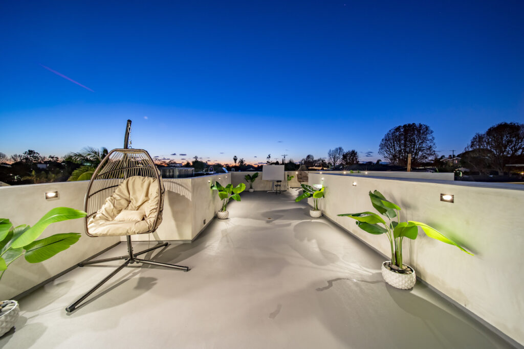 Rooftop terrace with hanging chair at dusk