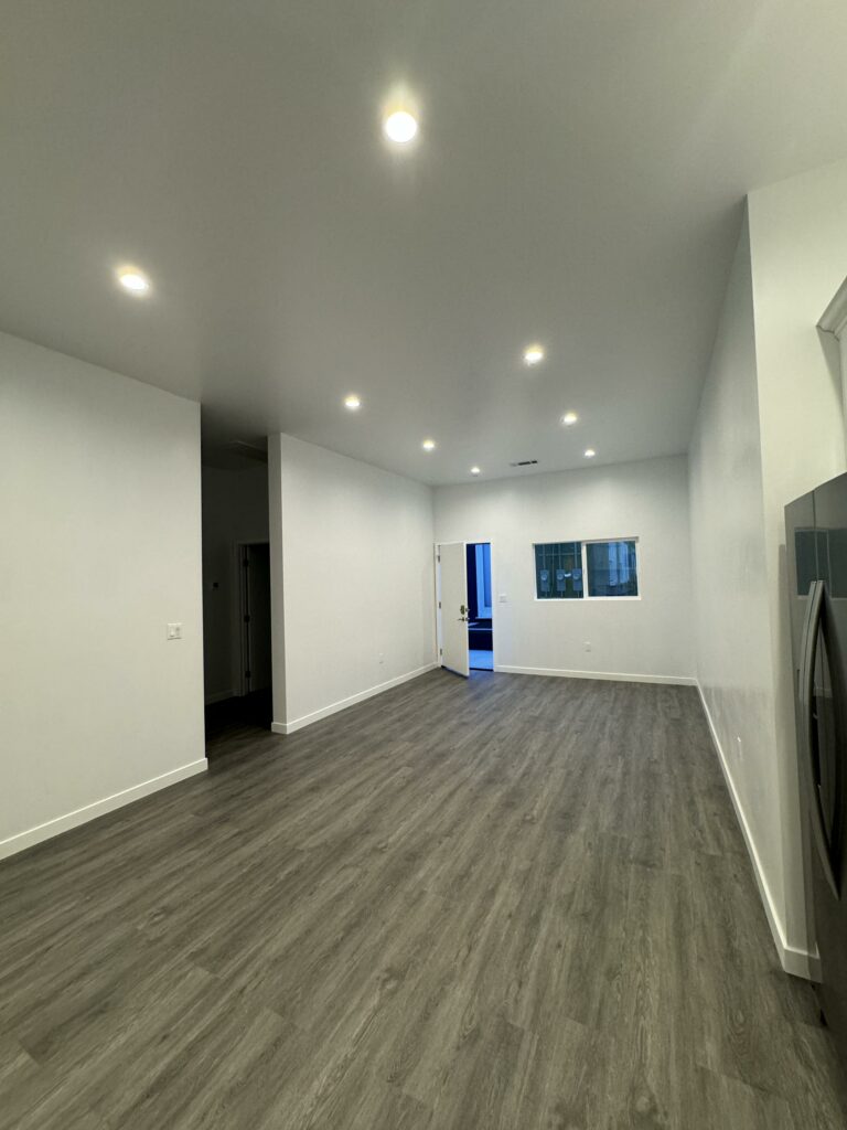 Empty room with gray flooring and white walls.