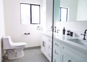 Bright modern bathroom with frosted window and white vanity.