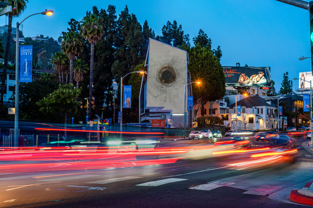 Sunset Strip at twilight with light trails and billboards.
