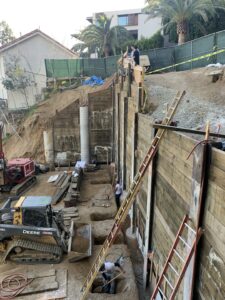 Construction site with workers and heavy machinery.